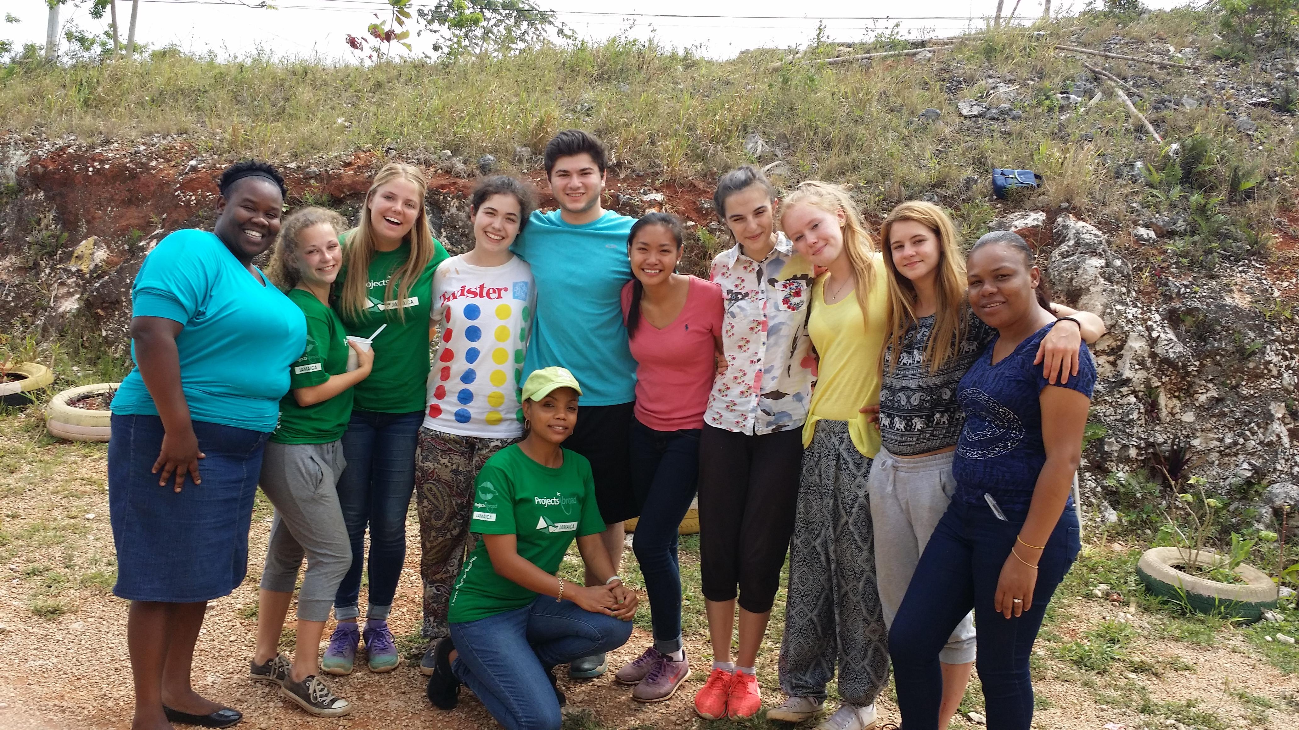 Projects Abroad high school student volunteers working with children, take a group photo with their supervisors in Jamaica. Volunteers working with children at a Summer Camp in Jamaica, take a photo with their local supervisors at their placement.